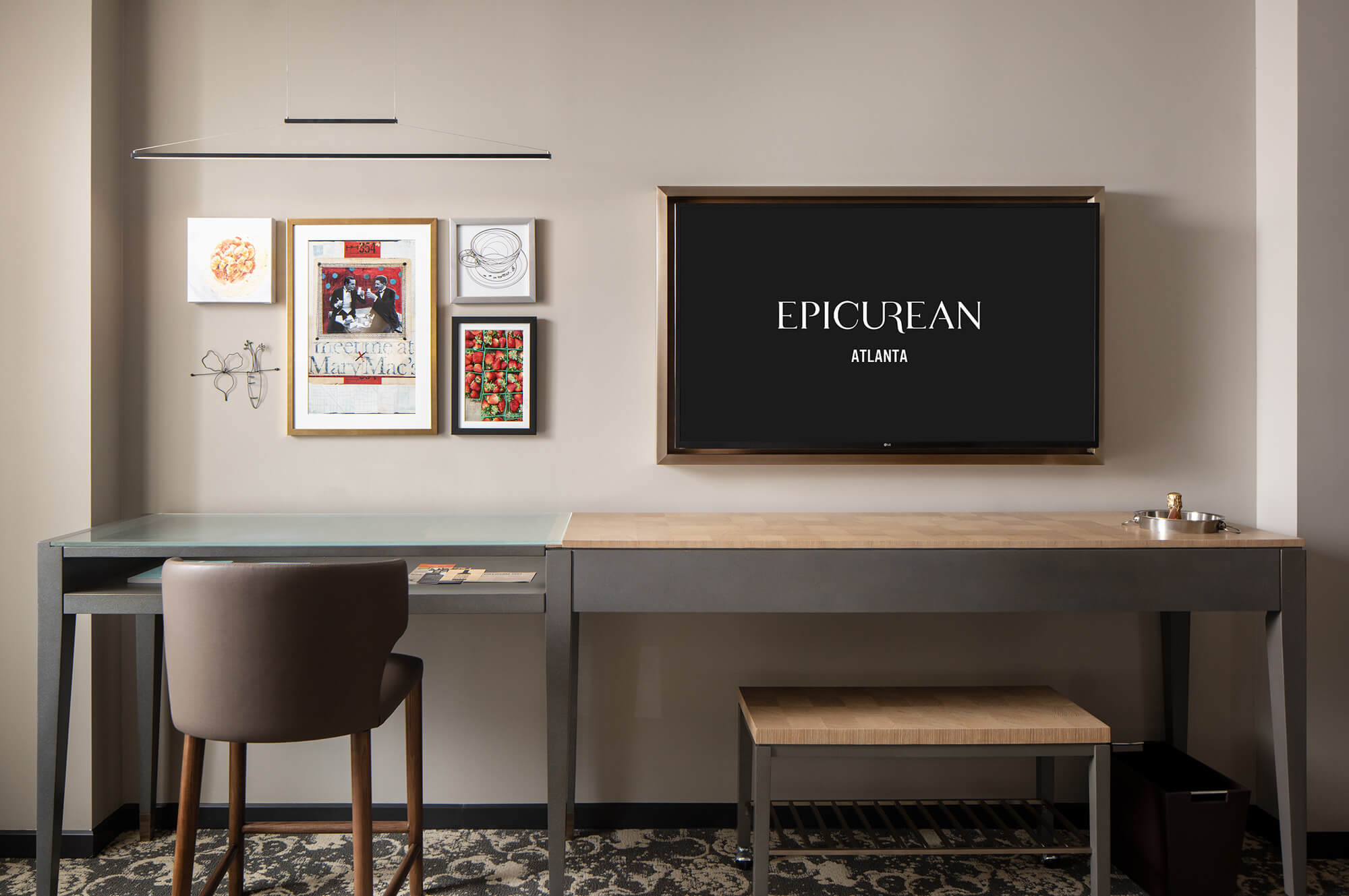 A view of some artwork and a desk in a guest room