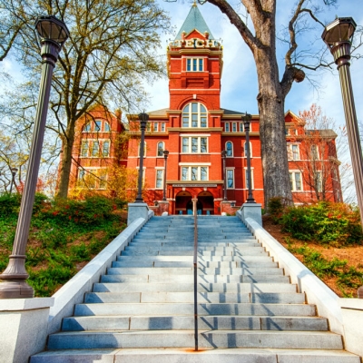 A view of a long cement staircase leading to the tall and church like building that is Georgia Tech