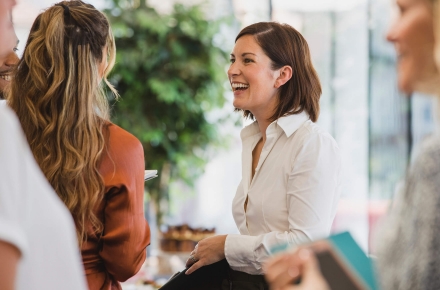 A woman engaging in conversation with another woman