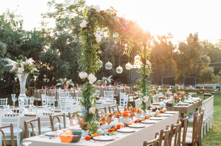 An outdoor dining experience with beautifully decorated tables for a wedding