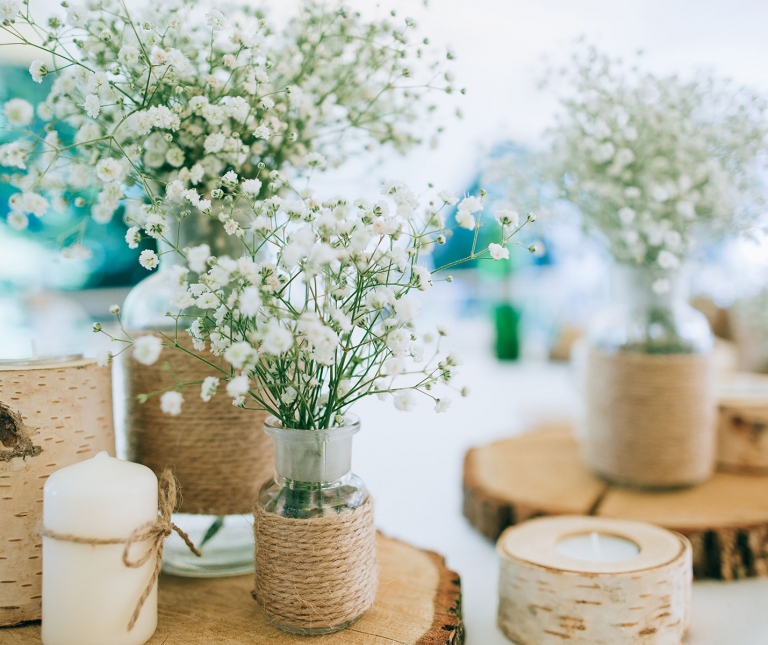 Some rustic wedding decorations including flowers and candles