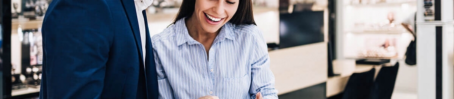 A man and woman looking at a watch in a storeA man and woman looking at a watch in a store