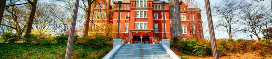 A view of a long cement staircase leading to the tall and church like building that is Georgia Tech