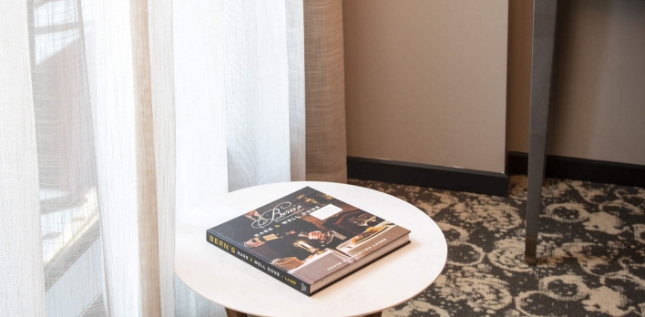 Sitting area with side table in a Junior King Balcony Suite