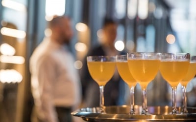 A group of glasses of liquid on a tray