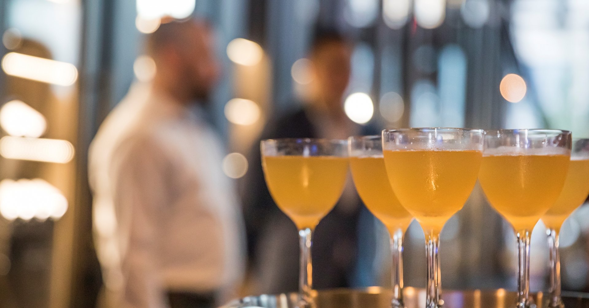 A group of glasses of liquid on a tray