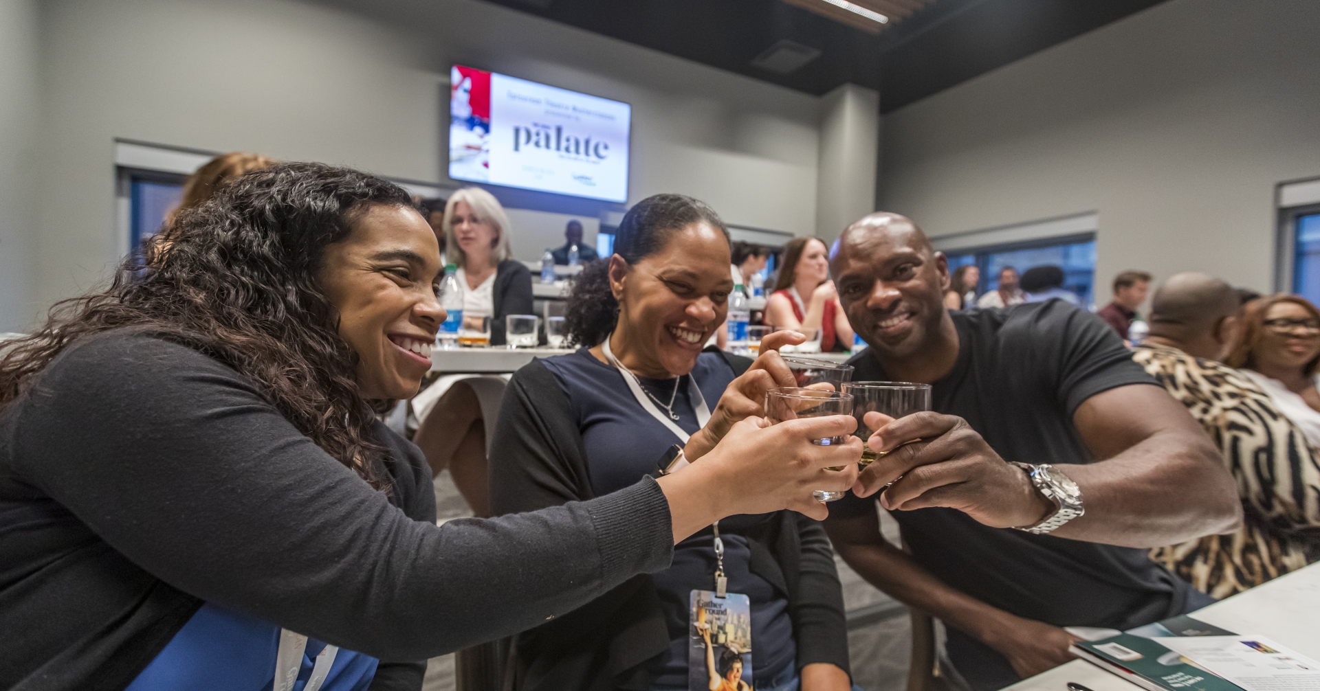 A group of people sitting at a table at Midtown Theatre event