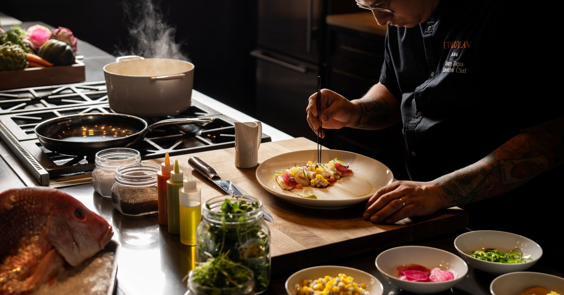 a chef preparing dinner in a Theatre at Epicurean Hotel in Midtown Atlanta